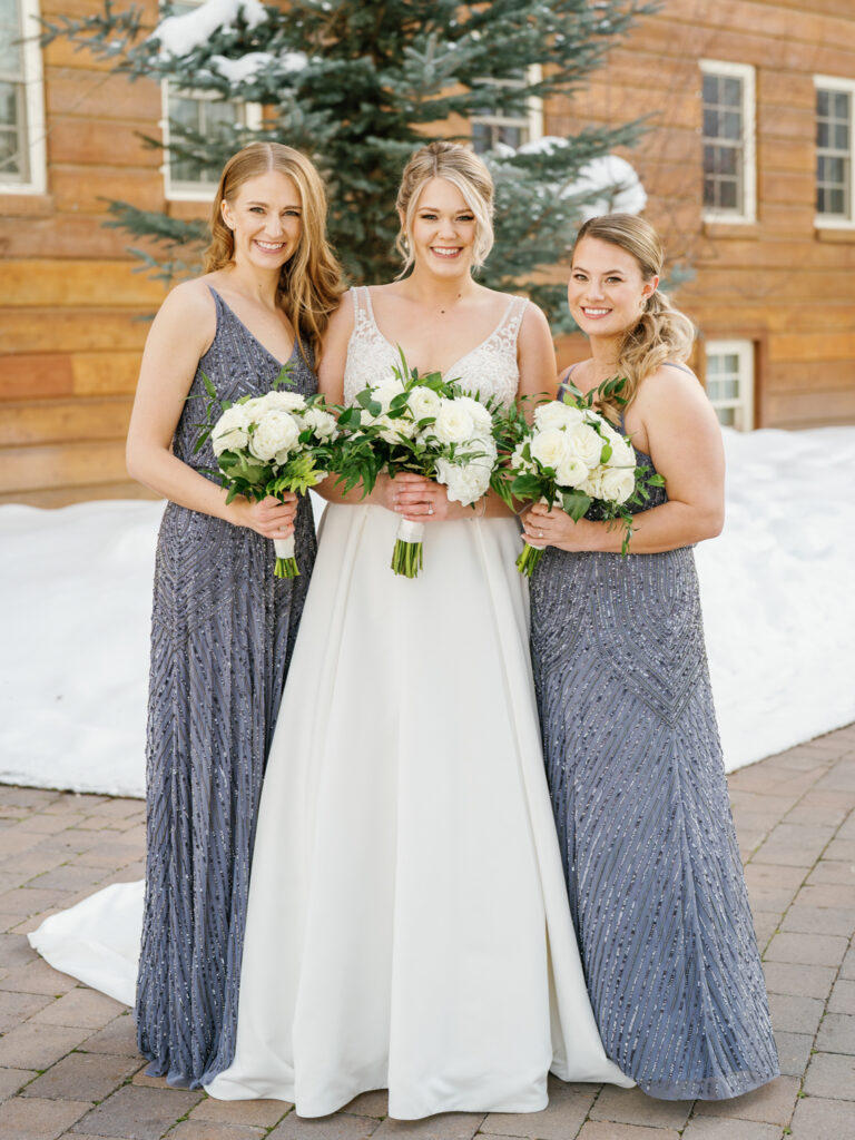 A Bride and Bridesmaids in dresses by BHLDN Weddings