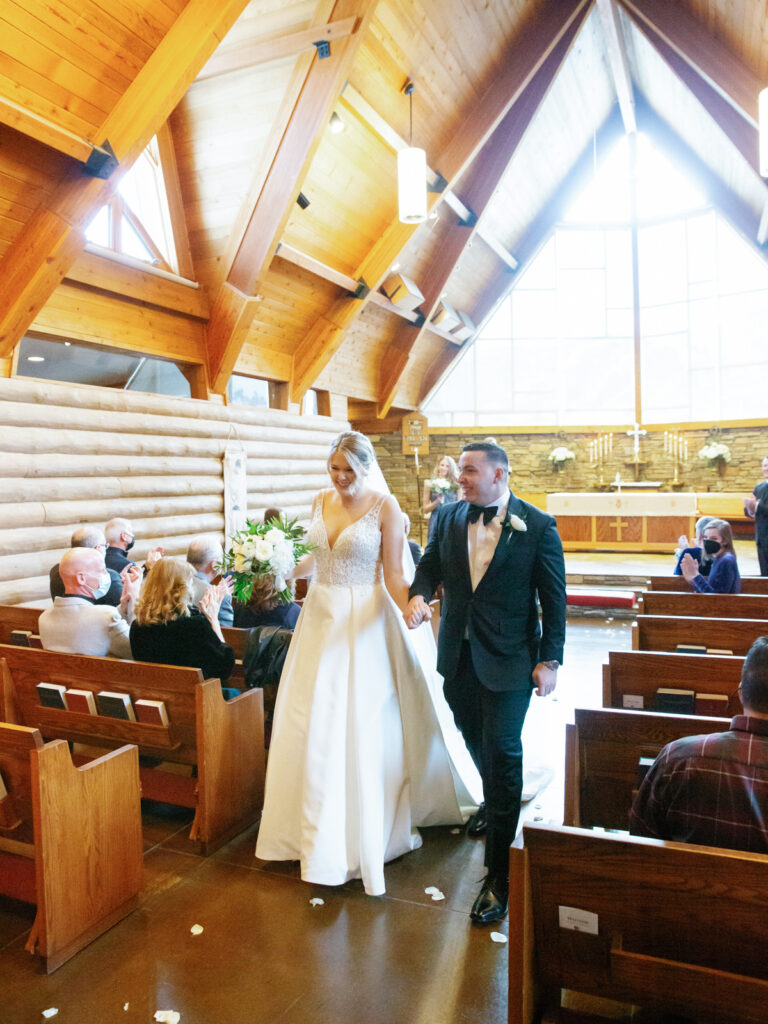Bride and Groom walking down the aisle after end of wedding ceremony at Saint Thomas Episcopal Church in Sun Valley
