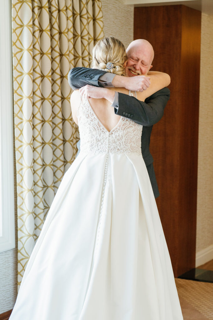 A Bride's first Look embrace with her father at Sun Valley Lodge before the wedding