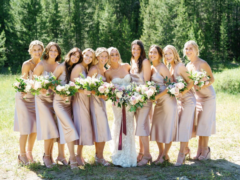 9 Bridesmaids in this Bridal party in Sun Valley's Galena Lodge wearing Grace Love's Lace Anya Dusk Dress and florals by Rust and Thistle
