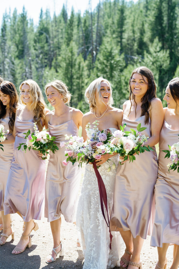 9 Bridesmaids with Bride in Sun Valley's Galena Lodge wedding wearing Grace Love's Lace Anya Dusk Dress and florals by Rust and Thistle