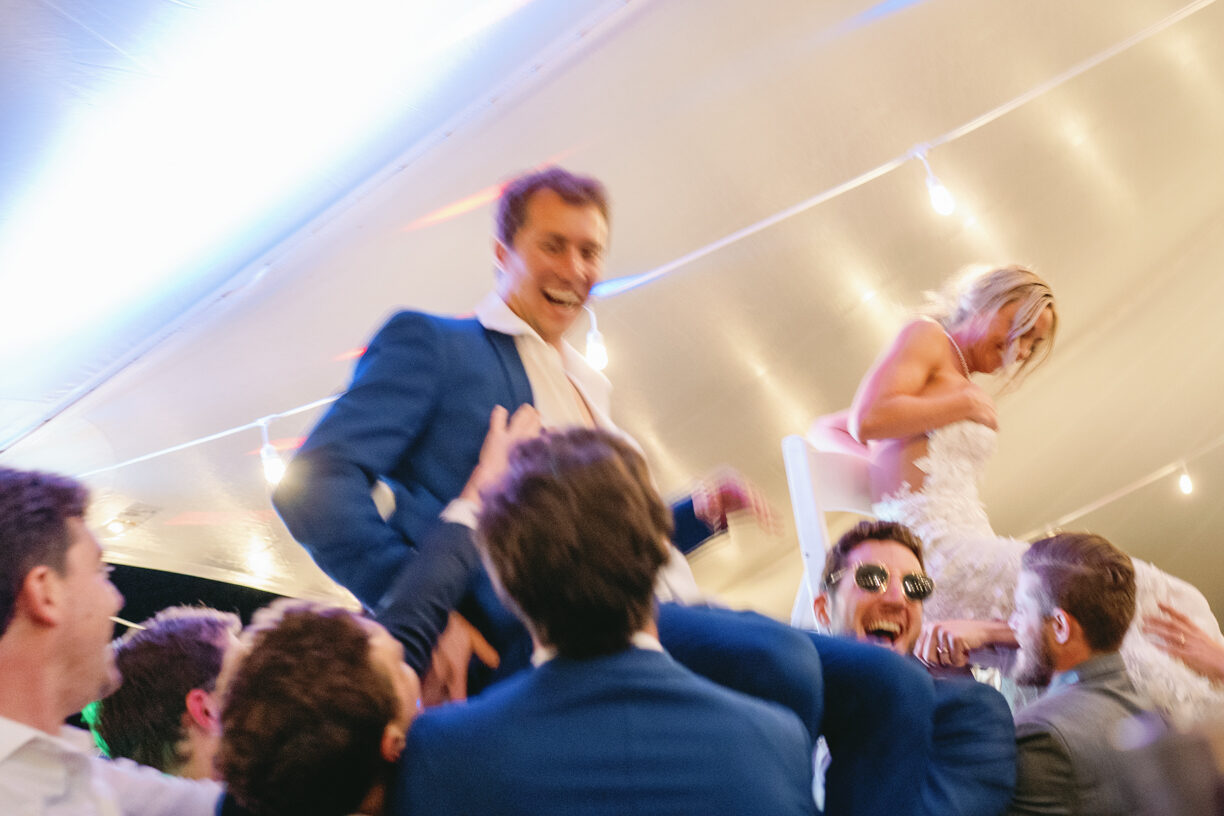 Bride and Groom lifted in chairs during wedding reception at galena lodge