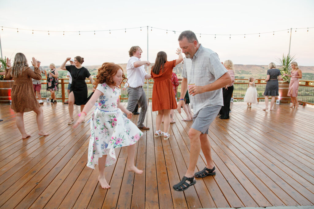 Boise Wedding Venue Fox Canyon Vineyard in Marsing bride groom dancing on deck